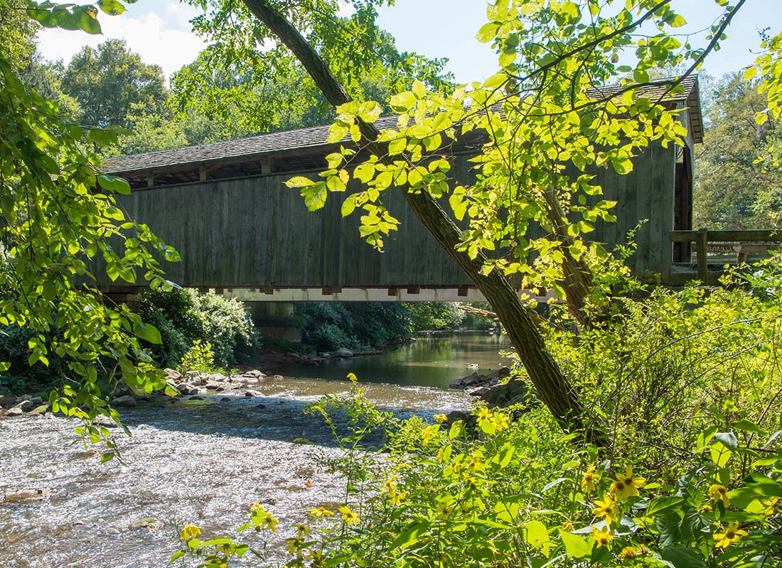 Lisbon, OH - Covered Bridge in a Forest on a Sunny Day
